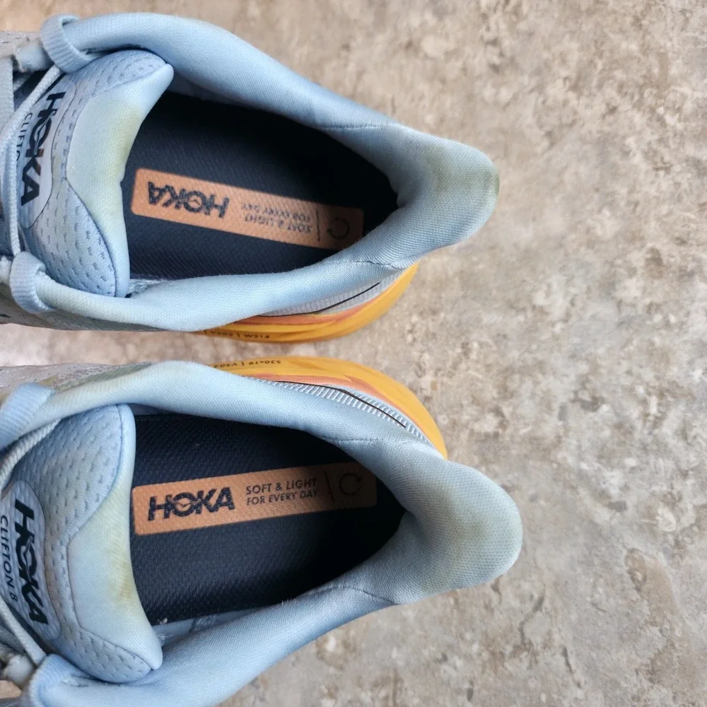 Hoka One One Women's Light Blue Running Shoes with Yellow and Orange Midsole
